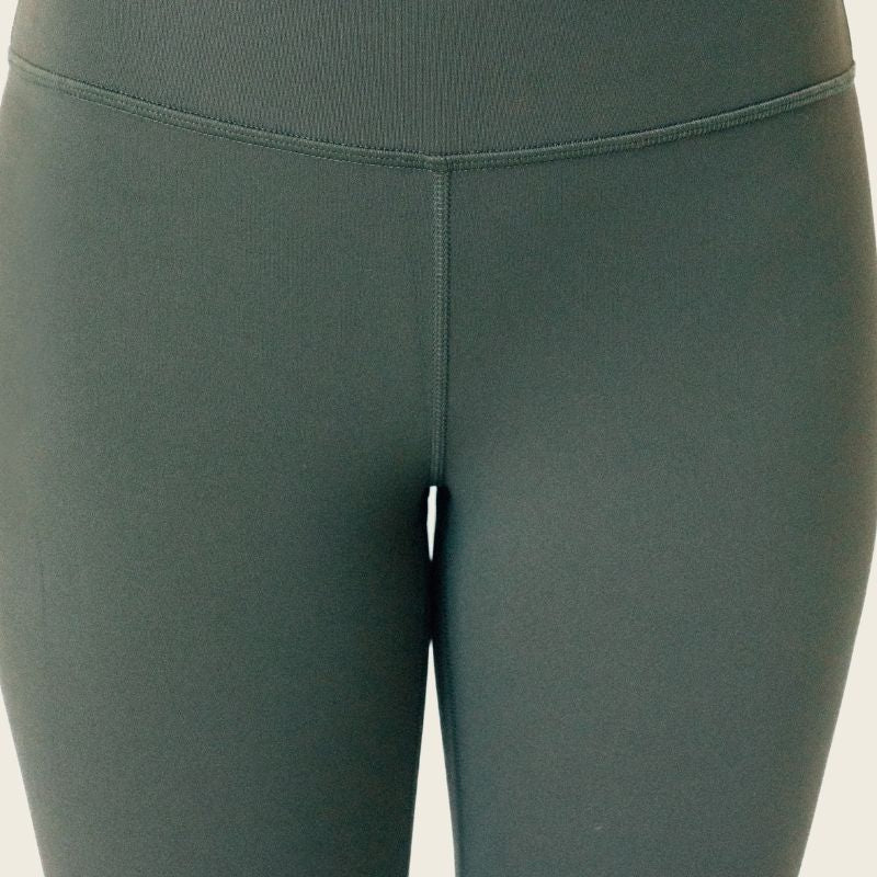 Close-up of green leggings after wearing Simply Clad camel toe proof thong, showing smooth, seamless fit with no visible camel toe.