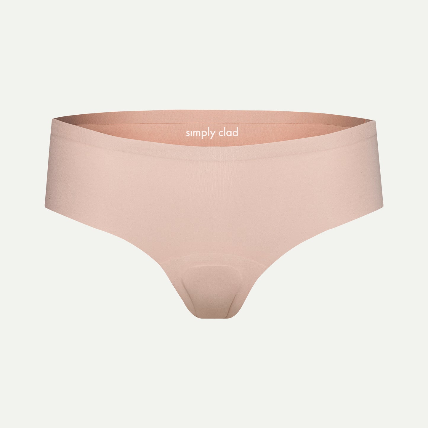 Beige camel toe proof thong underwear with seamless front and wide waistband, featuring “simply clad” logo — designed for invisible fit under leggings and everyday wear.