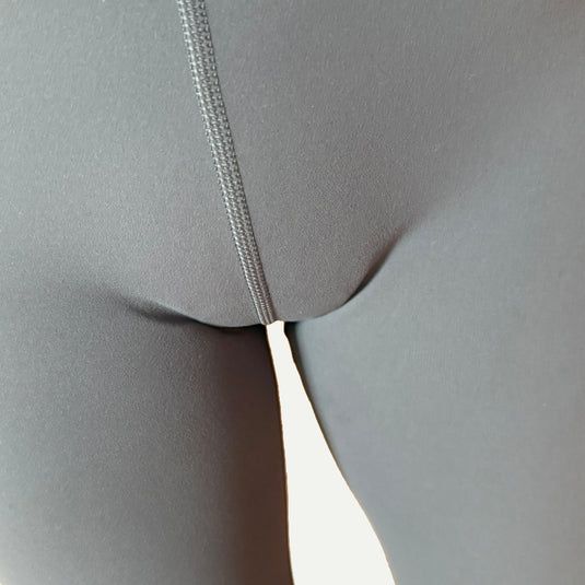 Close-up of gray leggings with Simply Clad camel toe proof underwear without visible lines and smooth fit.