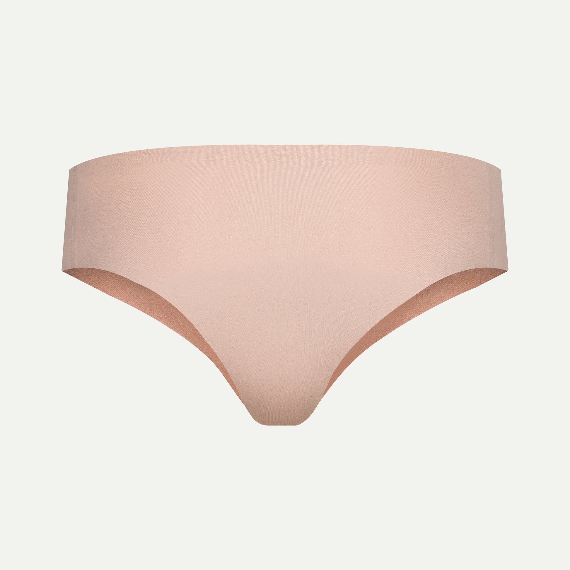 Back view of beige camel toe proof thong featuring a wide back panel for no wedgies, no digging in, and seamless comfort under leggings or tight clothing.