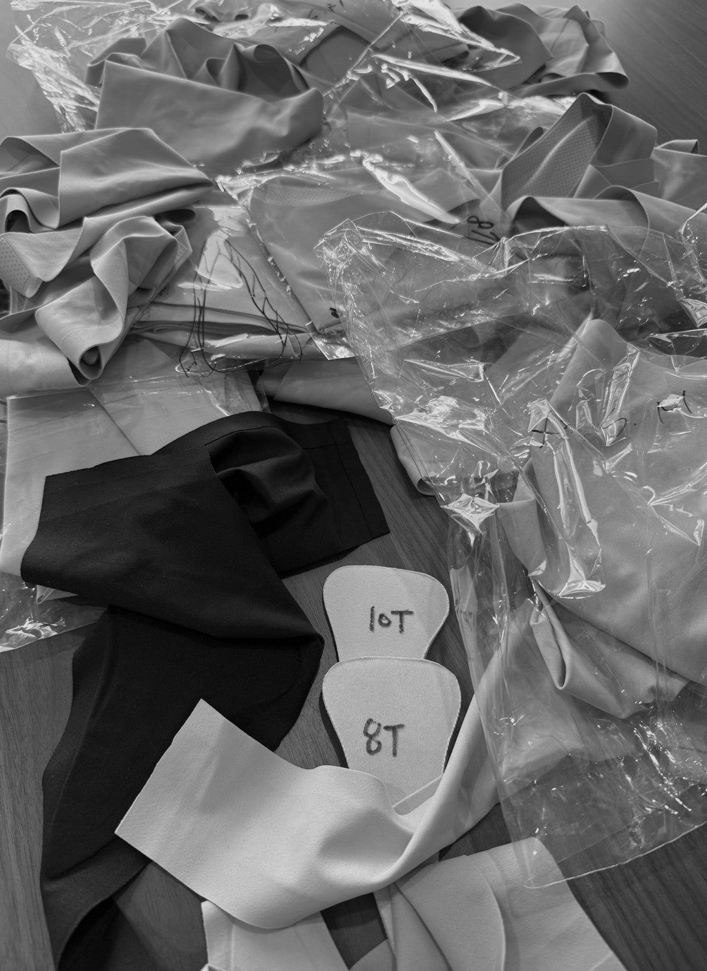 Stack of prototype camel toe proof thong samples showing early mockups, stitching tests, and torn fabric — highlighting product development and innovation process.