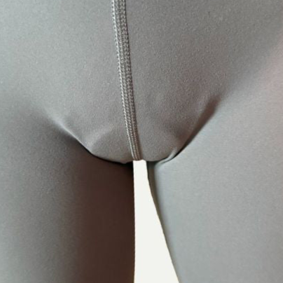 Close-up of gray leggings showing visible front outline caused by cheap camel toe concealing underwear. Budget options under $10–15 often have bulky, low-quality pads that fail to provide seamless coverage and show through clothing.